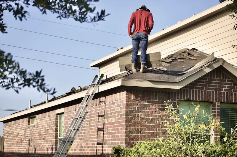 Professional roofer working on a residential roof in Crab Meadow